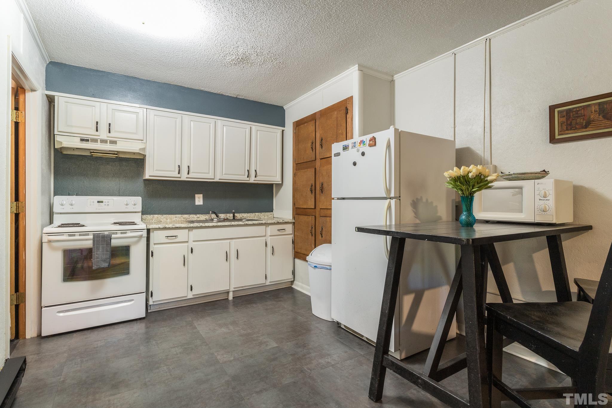 372 Cedar Lake Road Chapel Hill, NC 27516 - Photo 36 of 42 a white refrigerator freezer sitting in a kitchen