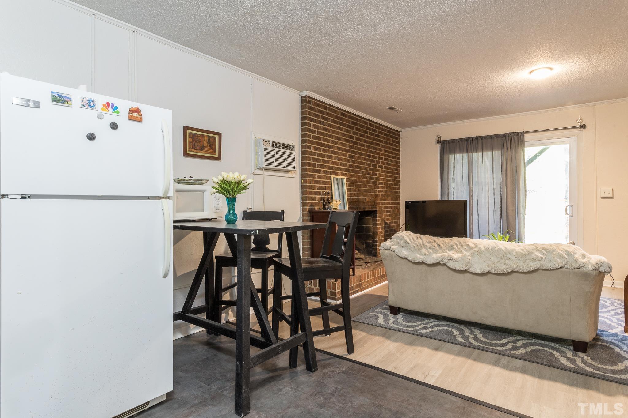 372 Cedar Lake Road Chapel Hill, NC 27516 - Photo 38 of 42 a living room with furniture and a refrigerator