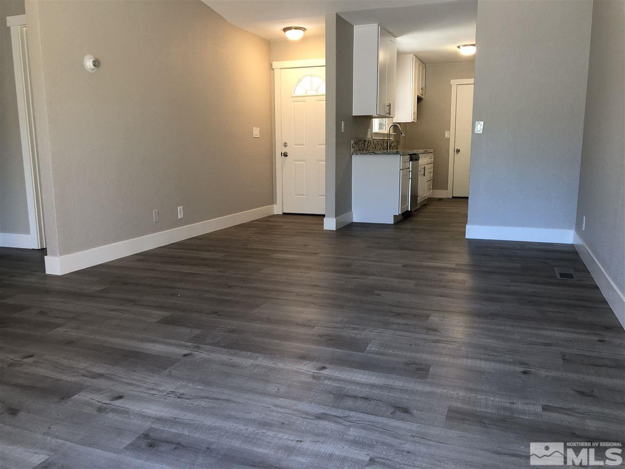 10028 Humite Lane Reno, NV 89506 - Photo 6 of 9 a view of a kitchen with kitchen island wooden floors and stainless steel appliances