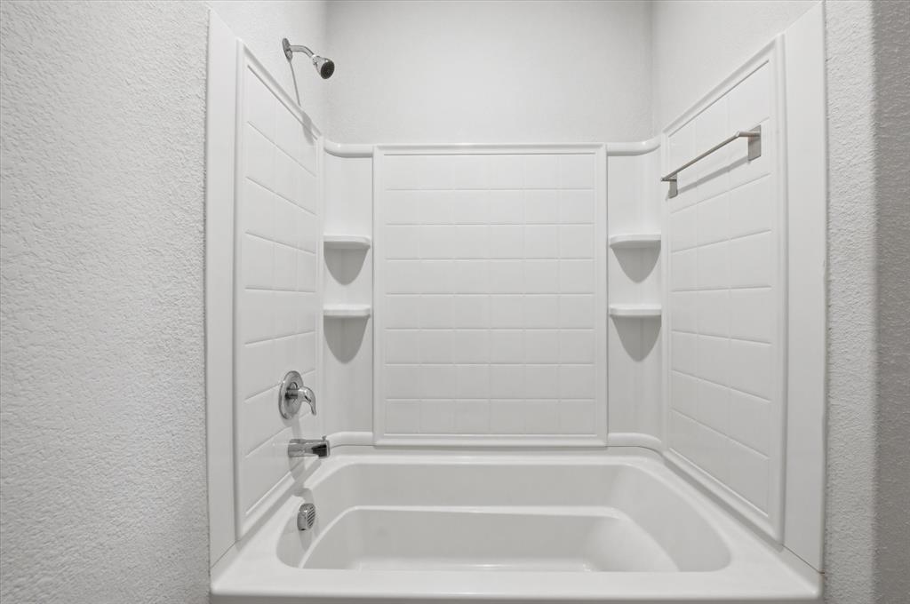 9308 Desertrock Road Fort Worth, TX 76131 - Photo 16 of 23 a close up of a bathtub curtain