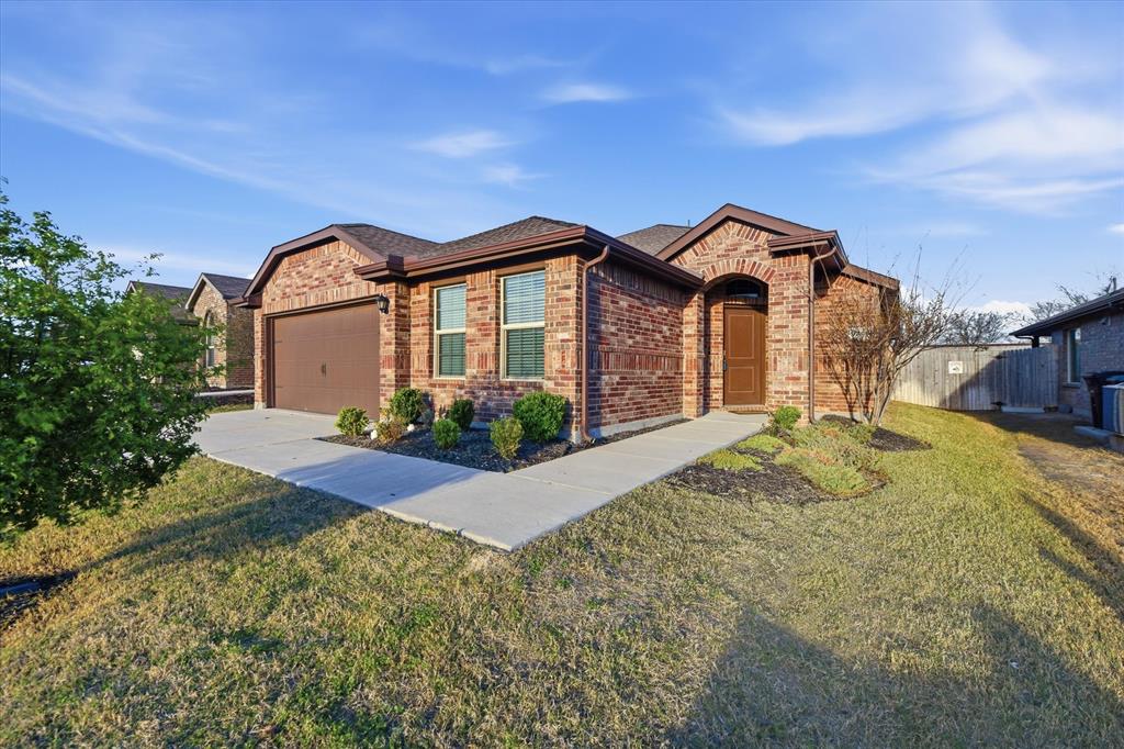 9308 Desertrock Road Fort Worth, TX 76131 - Photo 2 of 23 a front view of a house with a yard