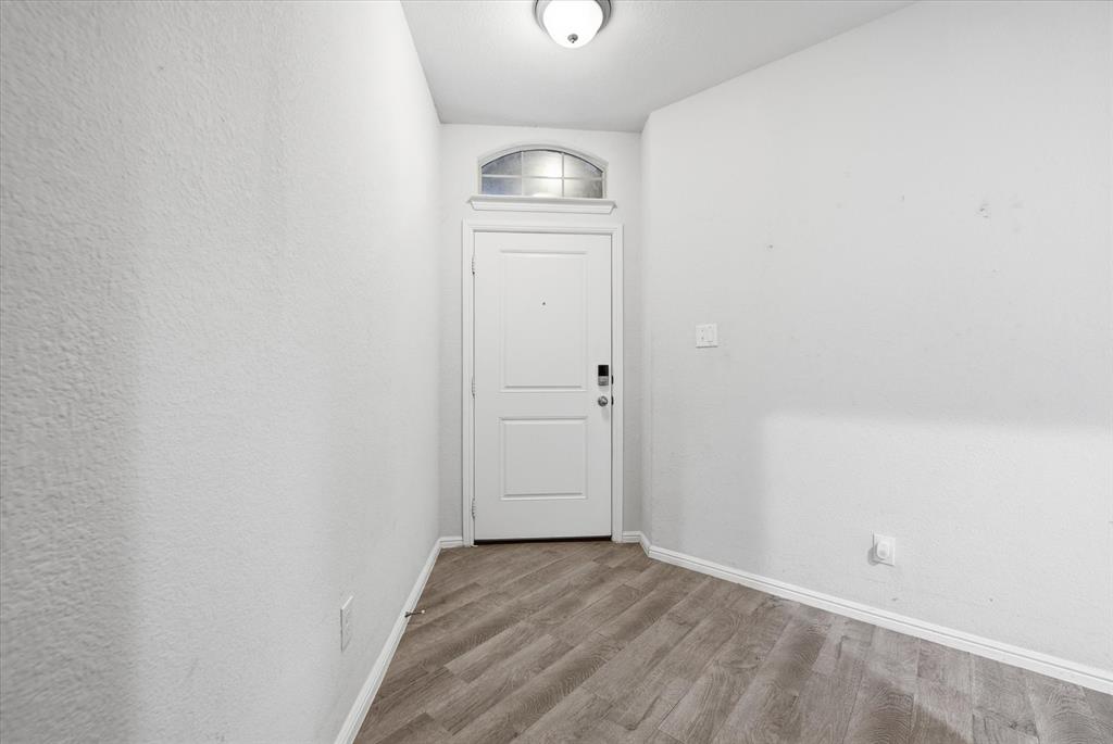 9308 Desertrock Road Fort Worth, TX 76131 - Photo 3 of 23 a view of empty room with wooden floor