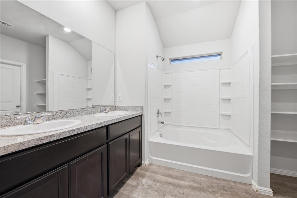 9308 Desertrock Road Fort Worth, TX 76131 - Photo 10 of 23 a bathroom with a granite countertop sink mirror bathtub and shower