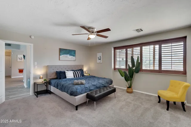 a living room with a bed furniture and a large window