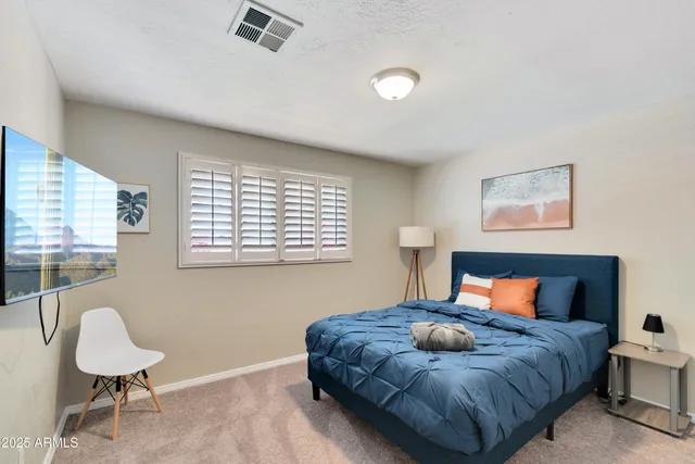 a bedroom with a bed and window