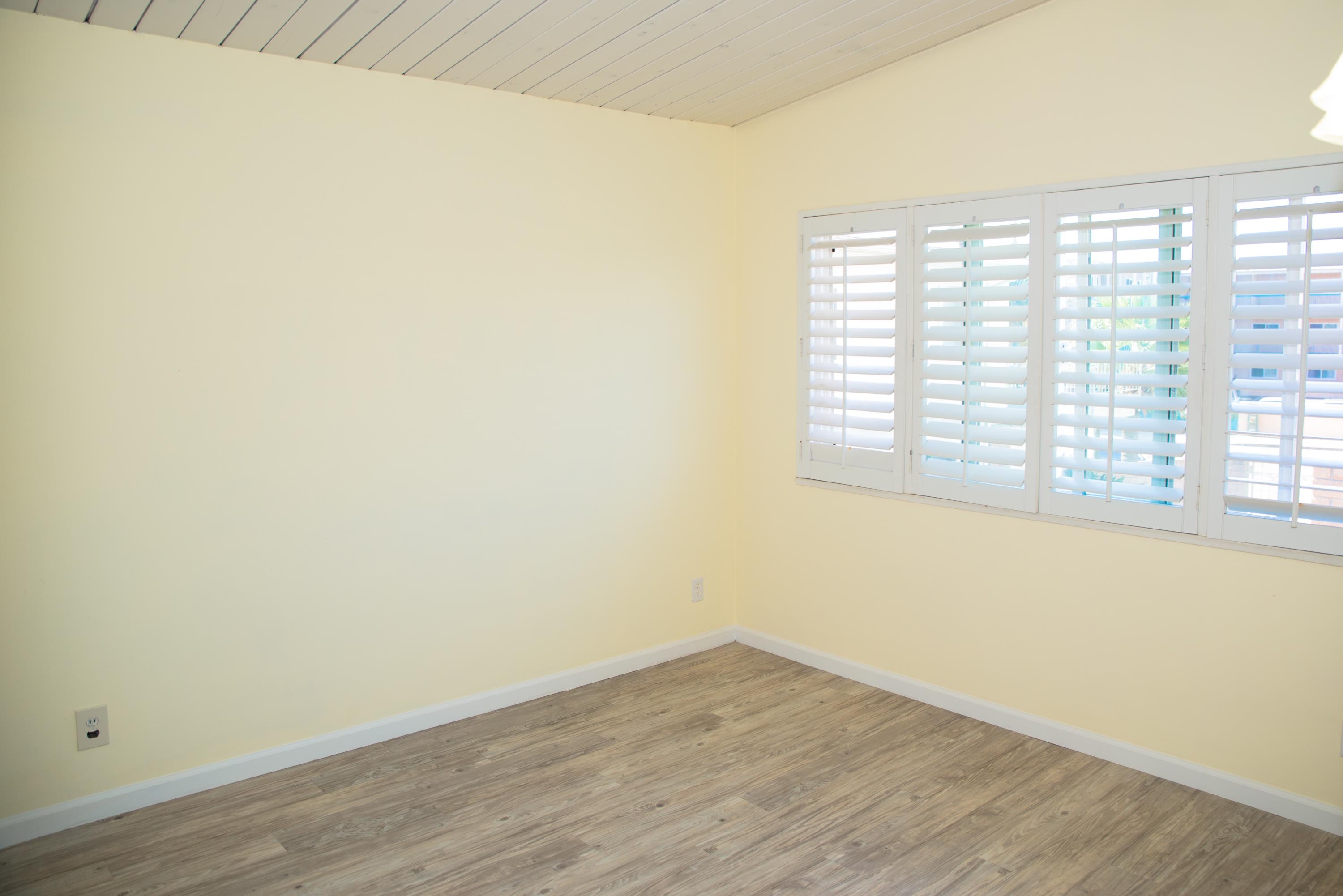 4950 Sandyland Road, Unit 220 Carpinteria, CA 93013 - Photo 14 of 20 a view of an empty room with wooden floor and a window