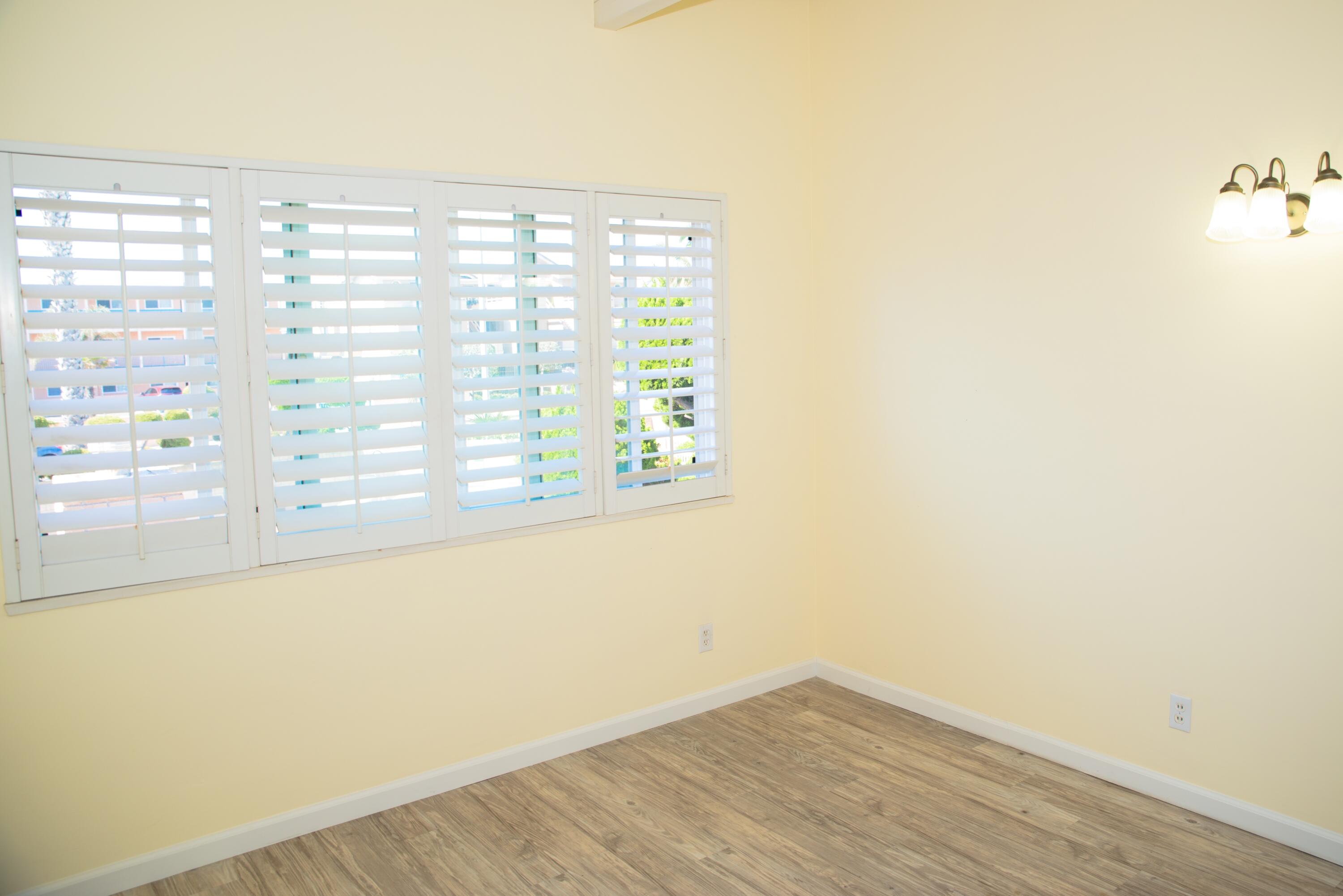 4950 Sandyland Road, Unit 220 Carpinteria, CA 93013 - Photo 17 of 20 a view of empty room with wooden floor and fan
