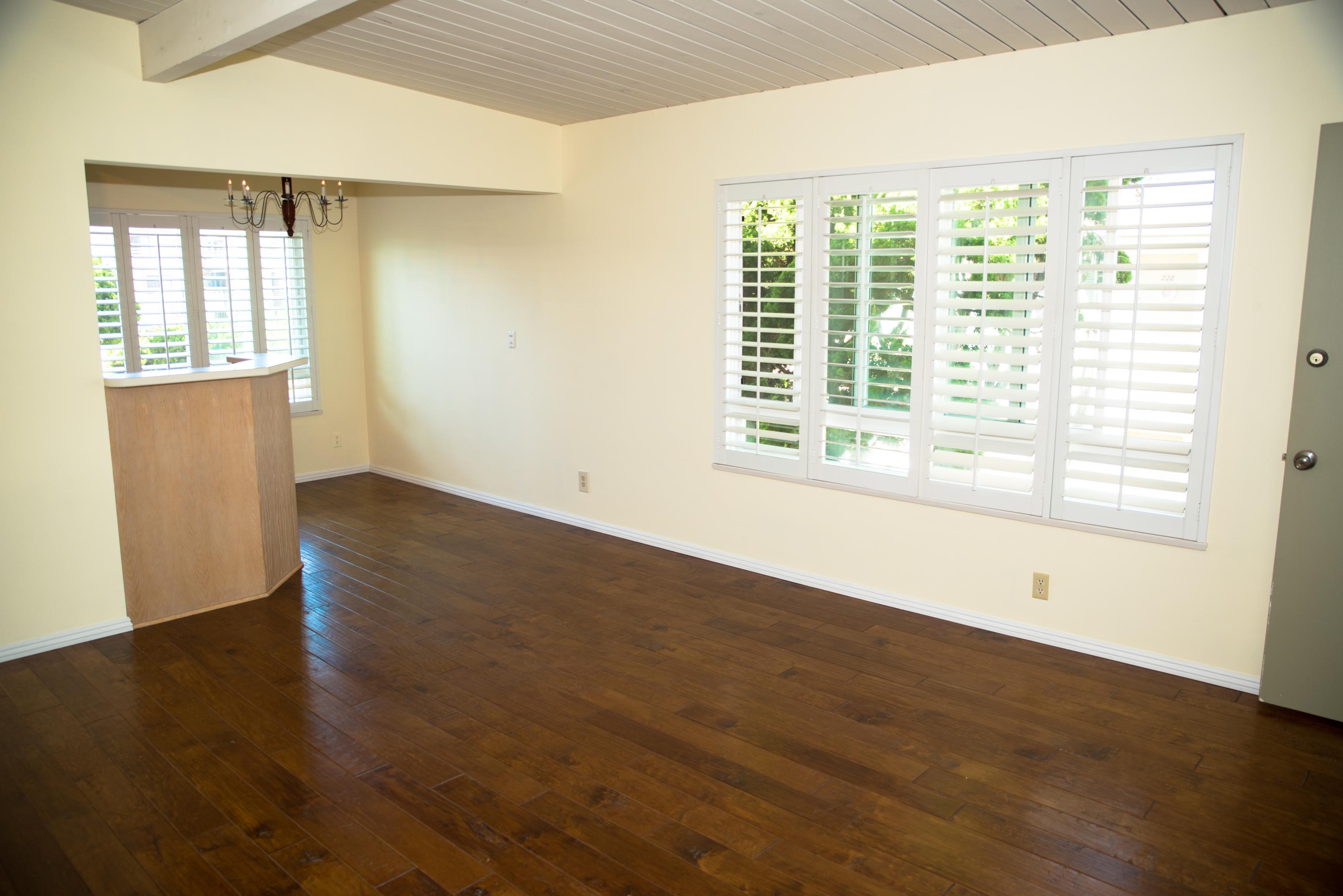 4950 Sandyland Road, Unit 220 Carpinteria, CA 93013 - Photo 5 of 20 a view of an empty room with wooden floor and a window