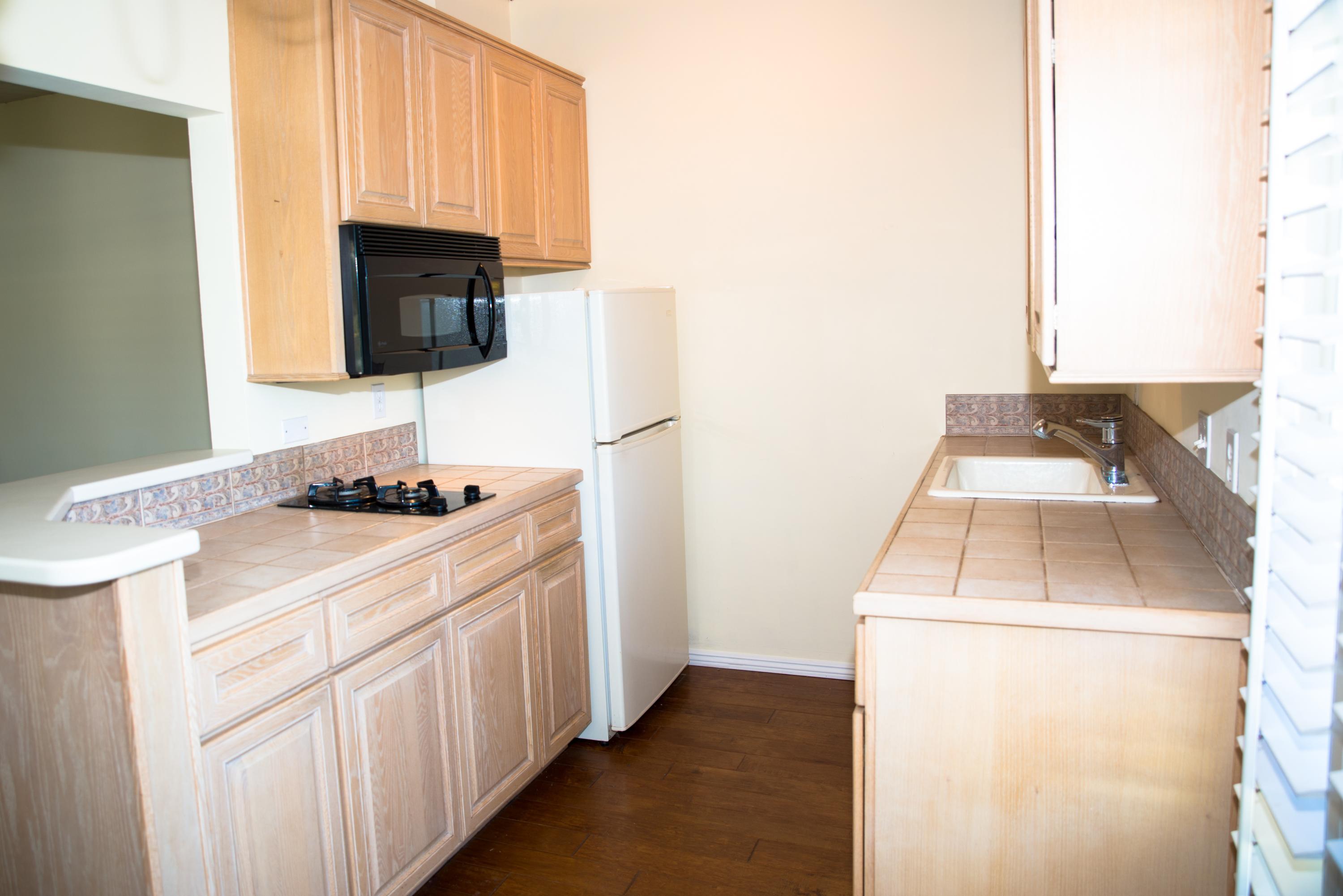 4950 Sandyland Road, Unit 220 Carpinteria, CA 93013 - Photo 9 of 20 a kitchen with a sink and a stove top oven