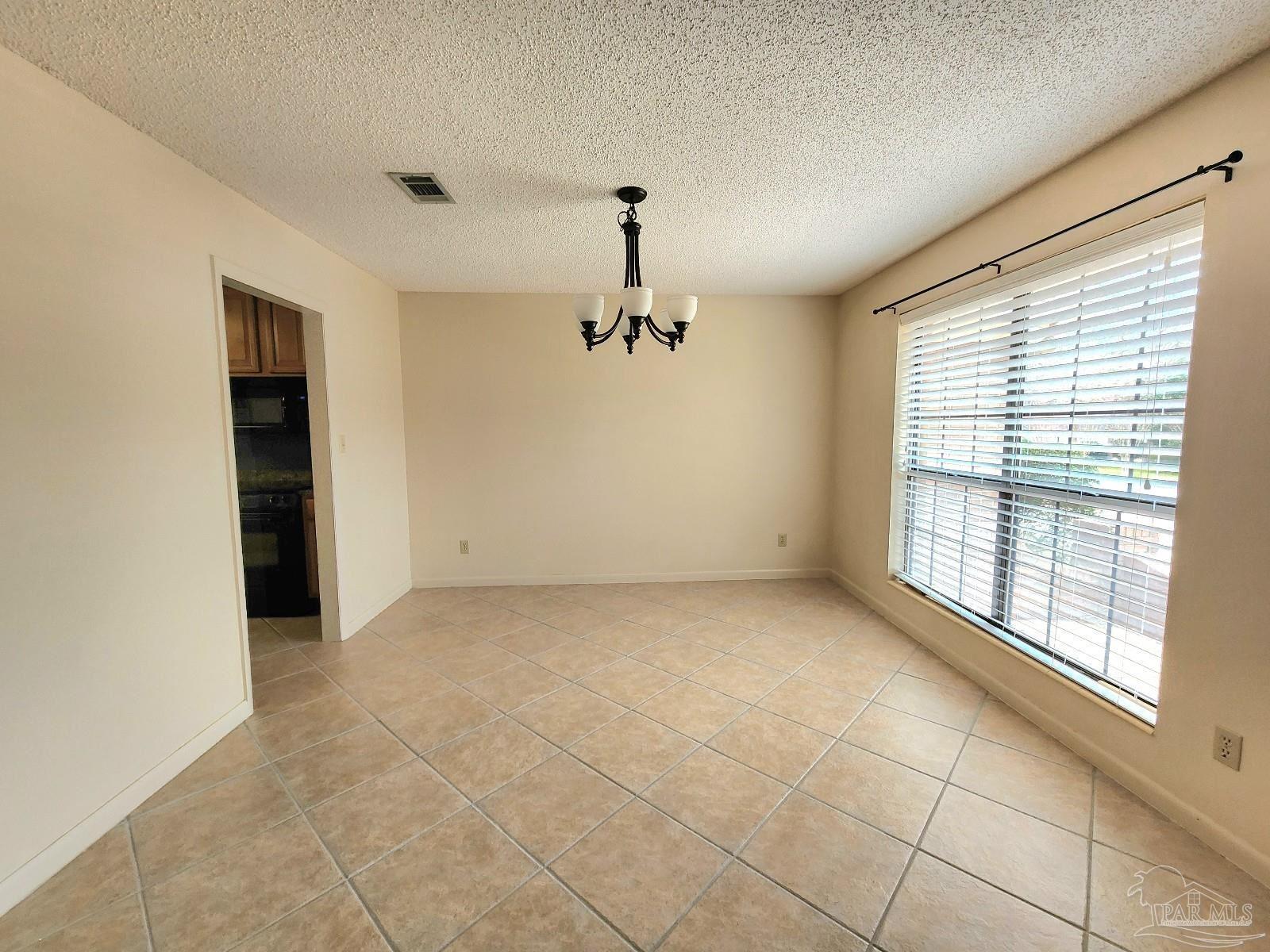 9001 Woodrun Road Pensacola, FL 32514 - Photo 11 of 24 a view of an empty room with a window