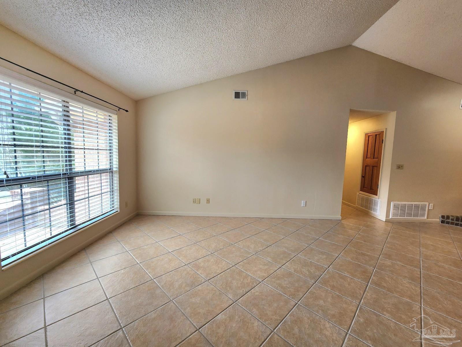 9001 Woodrun Road Pensacola, FL 32514 - Photo 12 of 24 a view of an empty room with a window