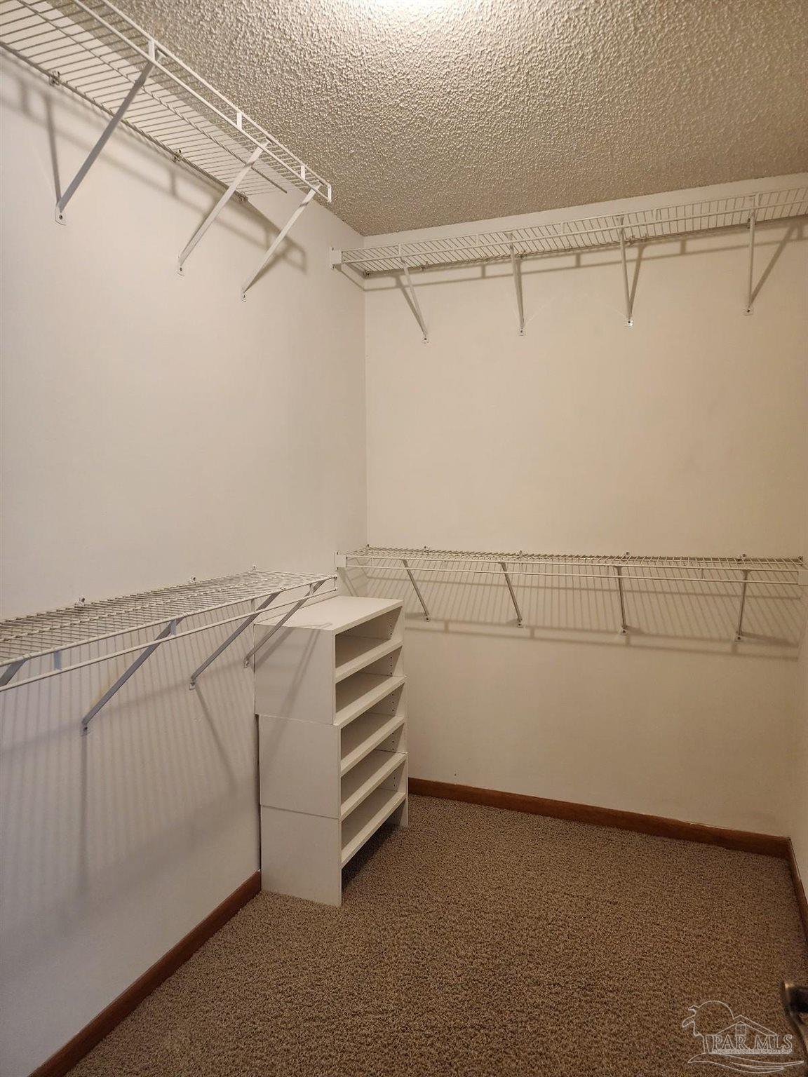 9001 Woodrun Road Pensacola, FL 32514 - Photo 17 of 24 a view of a room with racks on the wall