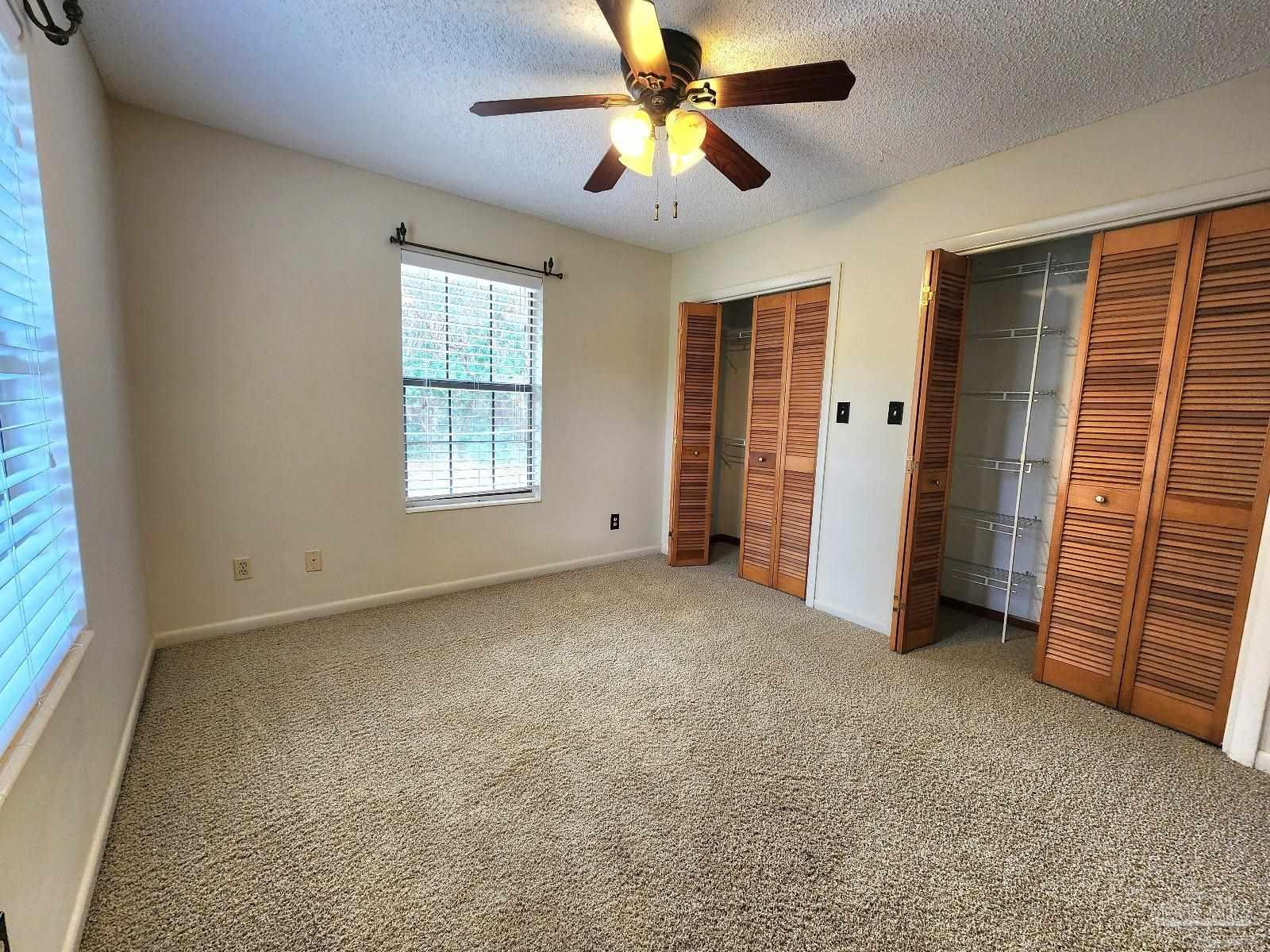 9001 Woodrun Road Pensacola, FL 32514 - Photo 19 of 24 a view of empty room with windows and fan