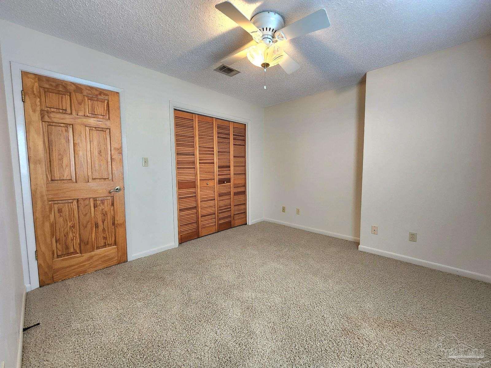 9001 Woodrun Road Pensacola, FL 32514 - Photo 20 of 24 an empty room with windows and closet