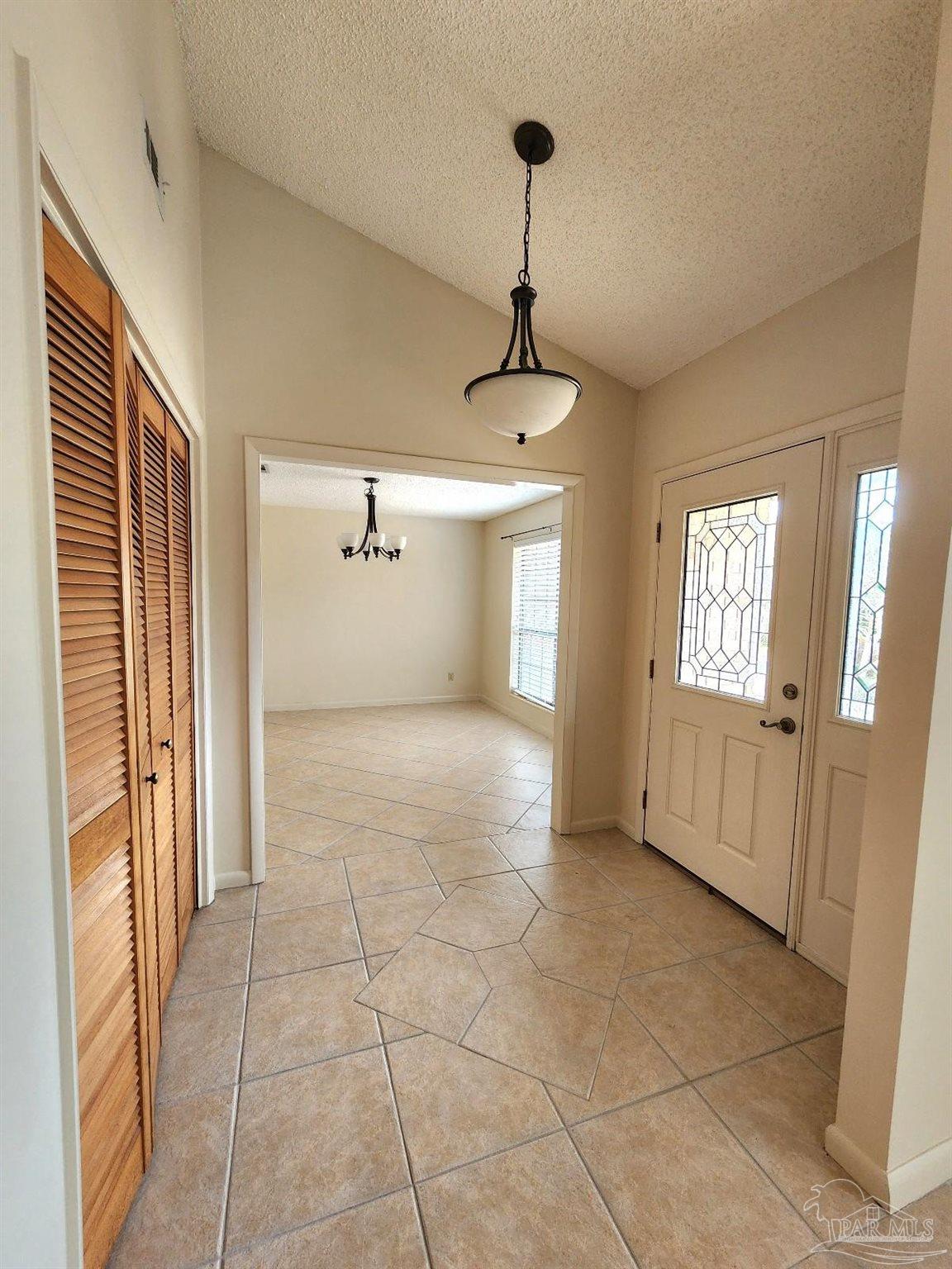 9001 Woodrun Road Pensacola, FL 32514 - Photo 2 of 24 a view of a hallway with windows and chandelier