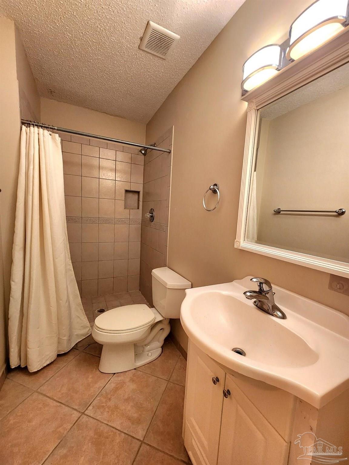 9001 Woodrun Road Pensacola, FL 32514 - Photo 21 of 24 a bathroom with a sink toilet and shower