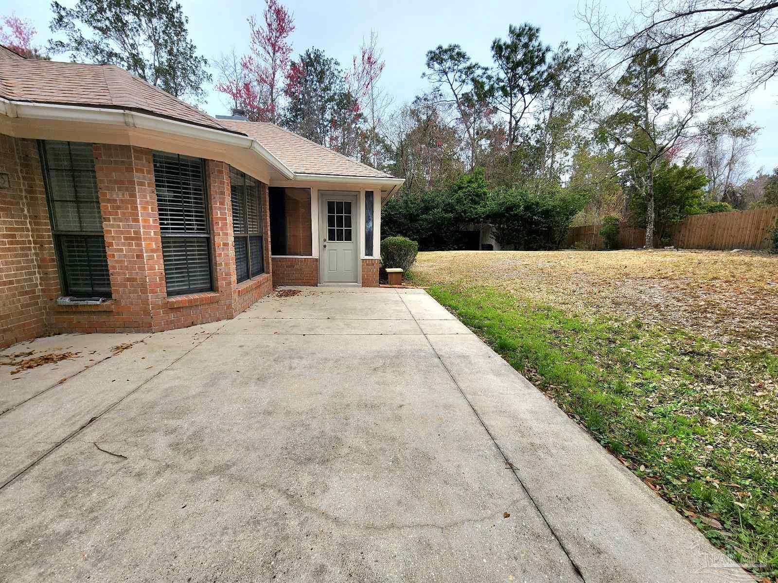 9001 Woodrun Road Pensacola, FL 32514 - Photo 23 of 24 a view of house with yard