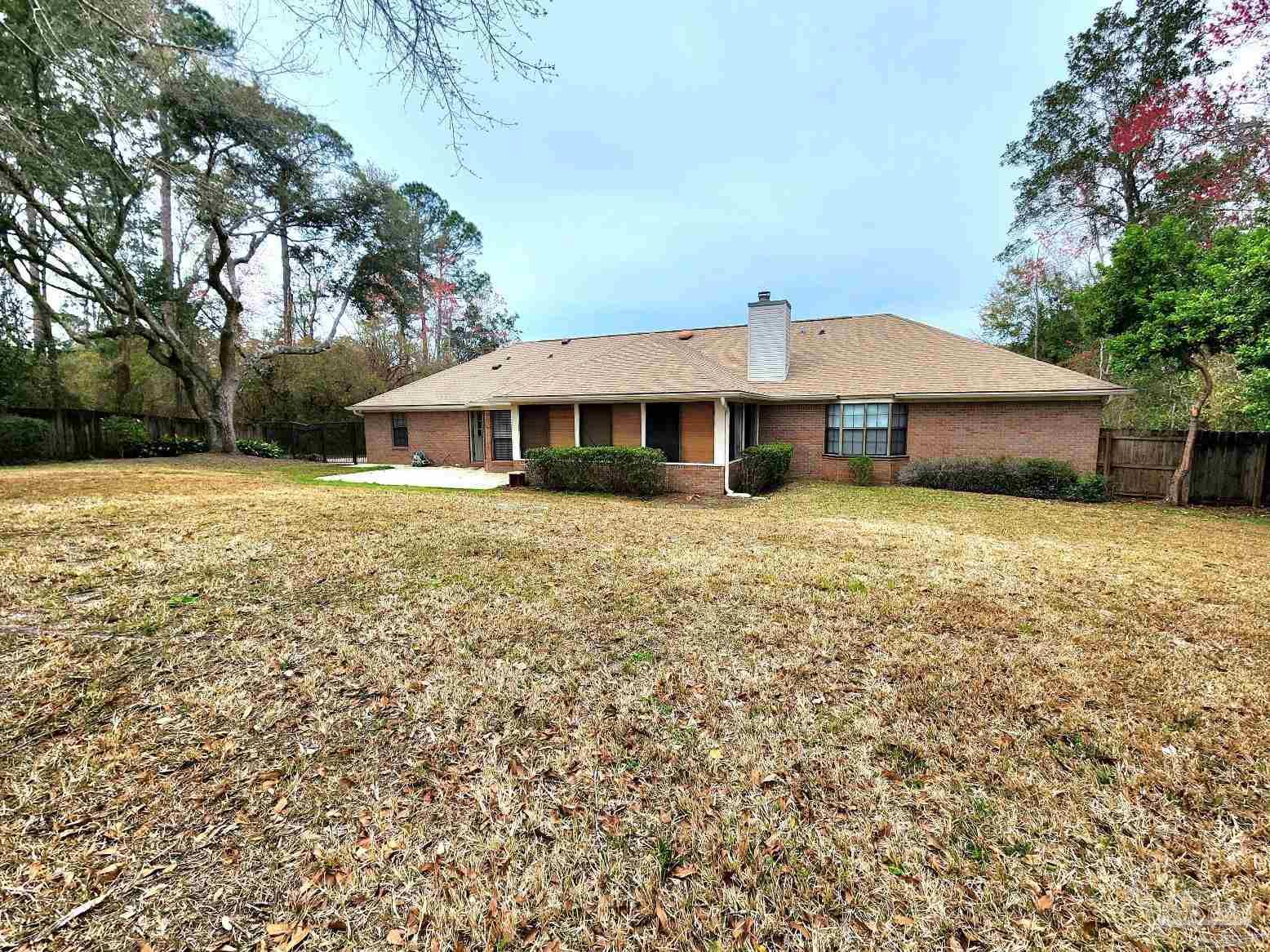9001 Woodrun Road Pensacola, FL 32514 - Photo 24 of 24 a front view of a house with garden