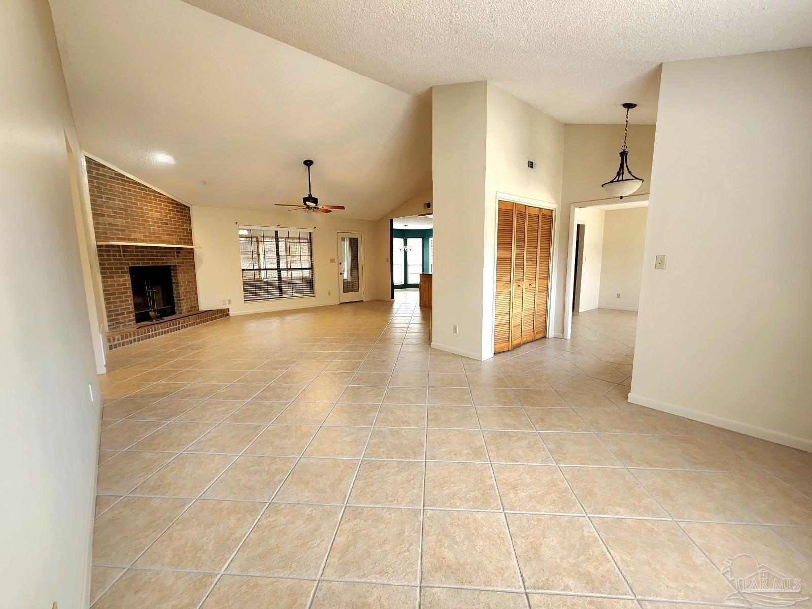 9001 Woodrun Road Pensacola, FL 32514 - Photo 7 of 24 a view of a kitchen with furniture and a fireplace