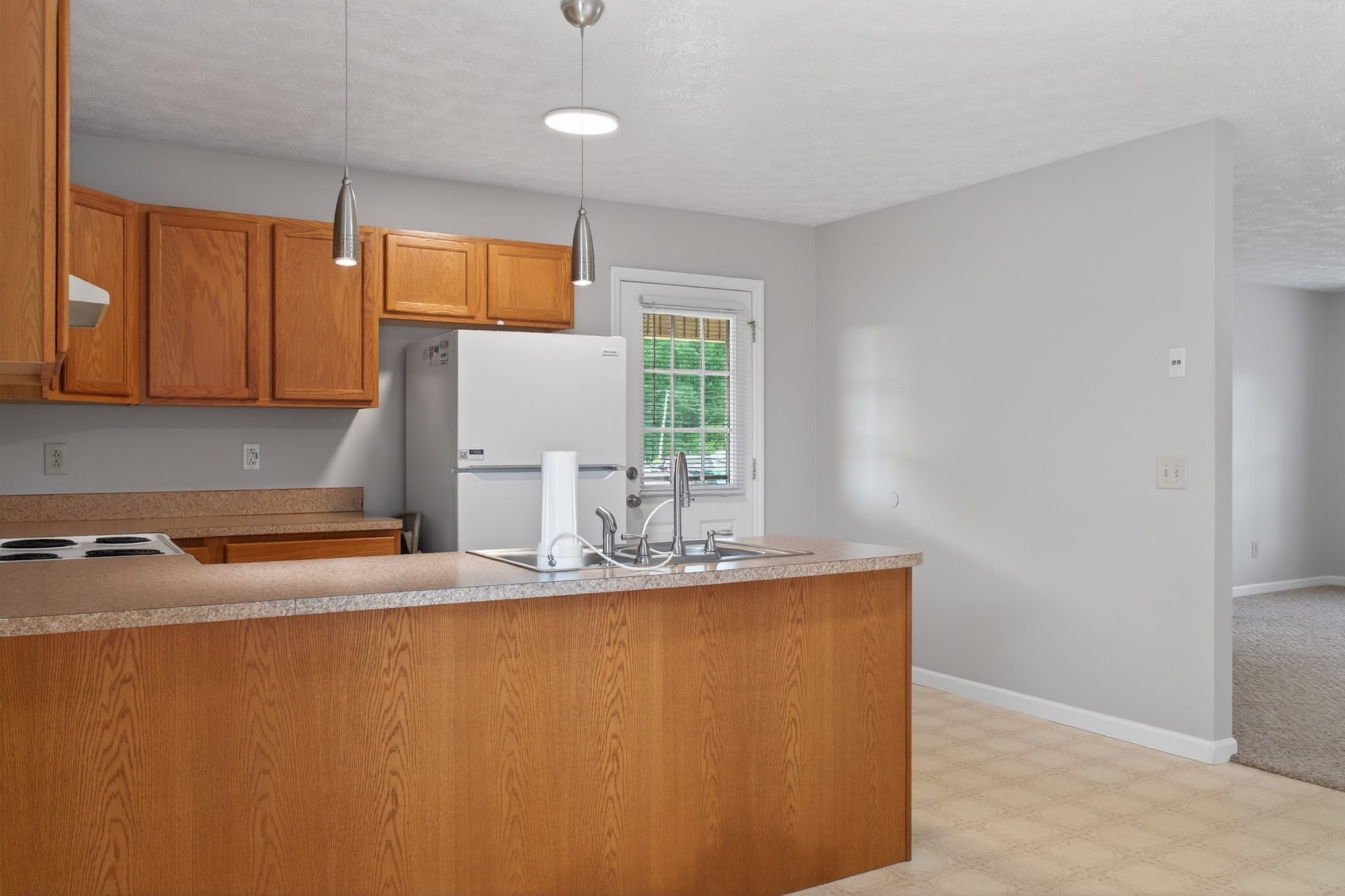 618 Lear Road Portland, TN 37148 - Photo 16 of 29 a room with kitchen island a sink a stove and a window