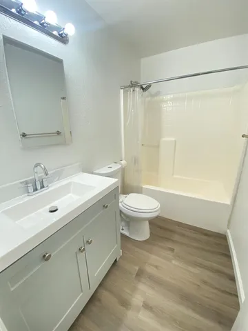 a bathroom with a sink toilet a mirror and shower