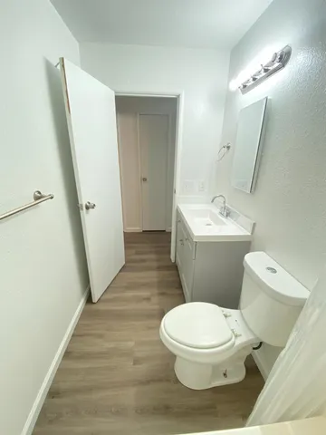 a white toilet sitting next to a bathroom sink