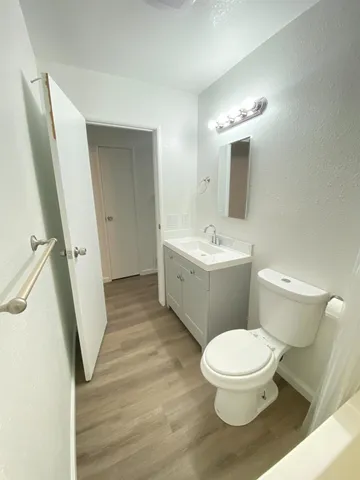 a white toilet sitting next to a bathroom sink