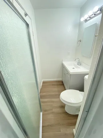 a bathroom with a sink toilet and shower