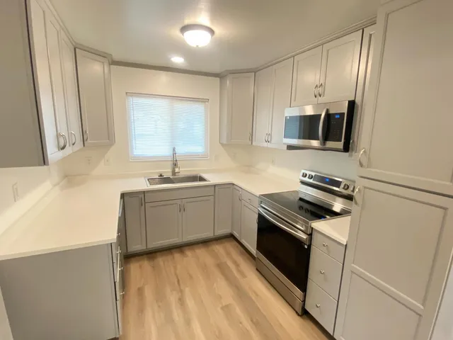 a kitchen with a sink stove and microwave