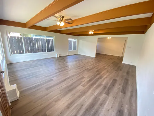 a view of a room with wooden floors