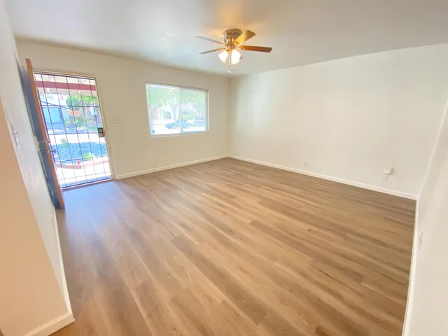 wooden floor in an empty room with a window