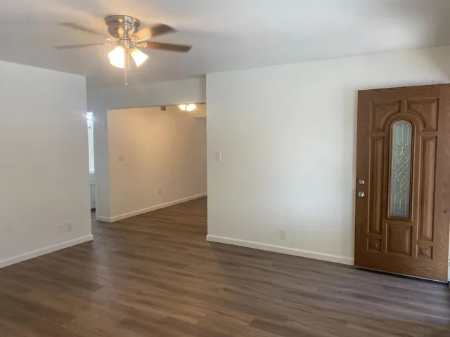 wooden floor in an empty room with a window
