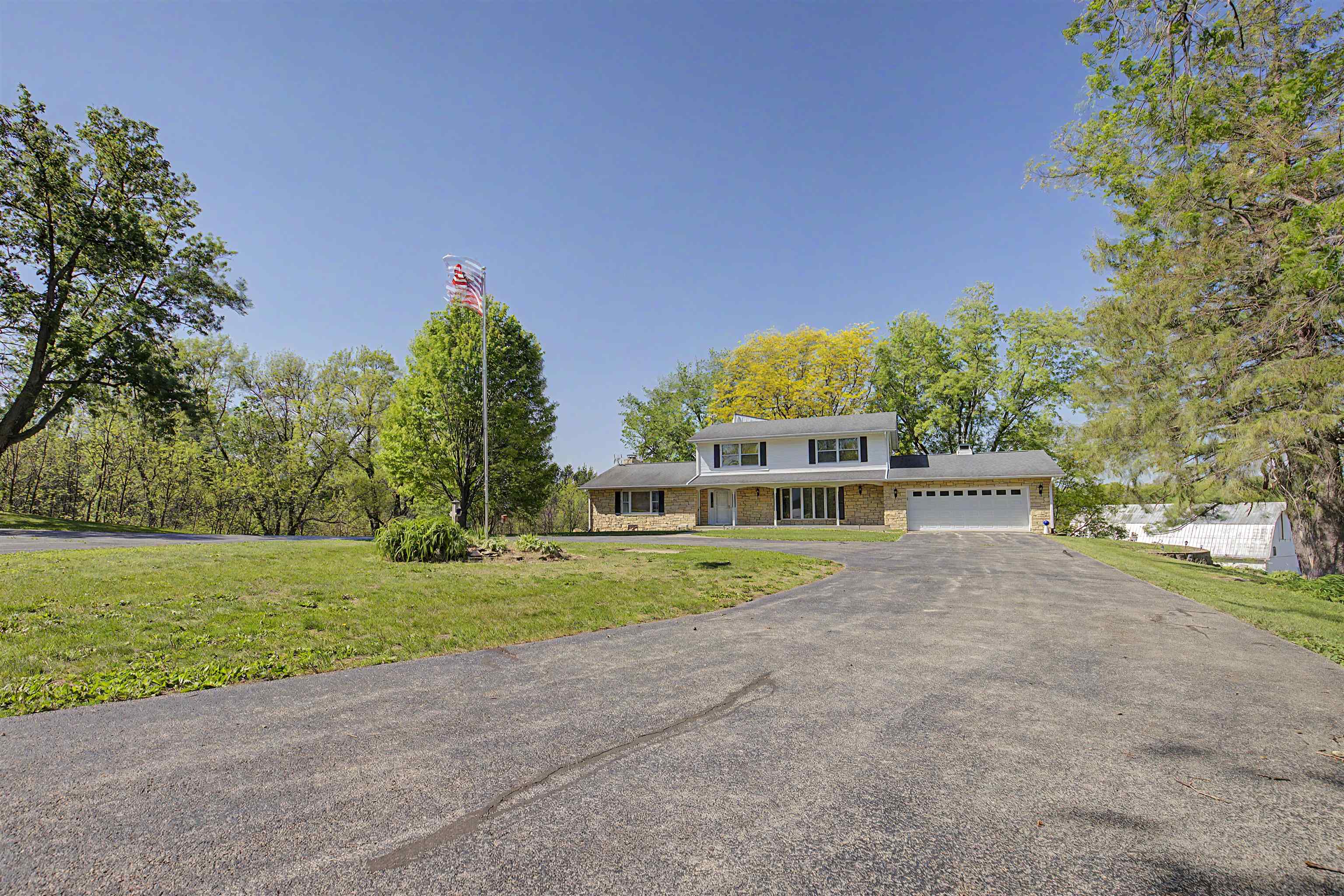 17380 Corbett Road Mount Carroll, IL 61053 - Photo 52 of 65 a view of a house with a yard and a car park fire pit
