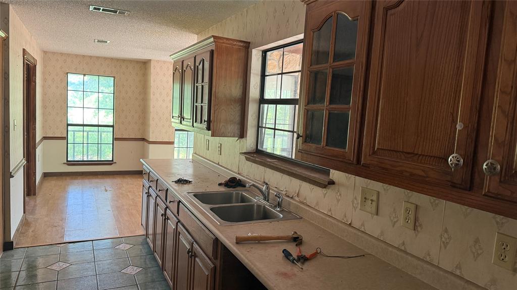 6582 Taylor Road Kaufman, TX 75142 - Photo 16 of 40 a kitchen with a sink and a stove top oven