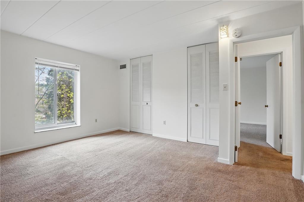 5 Bayard Road, Unit 400 Pittsburgh, PA 15213 - Photo 17 of 33 Neutral carpets and closets in a bedroom contribute to a calming and cohesive design.