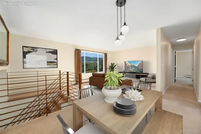 a living room with furniture a flat screen tv and a large window