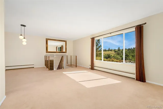 an empty room with windows and closet