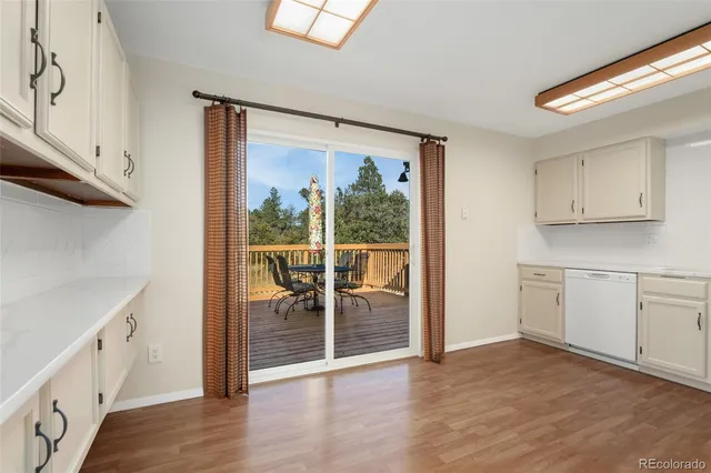 a view of a kitchen with wooden floor and a sink