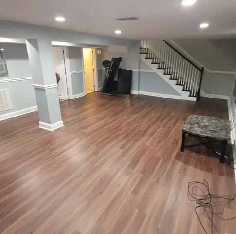 a hallway with wooden floor and furniture