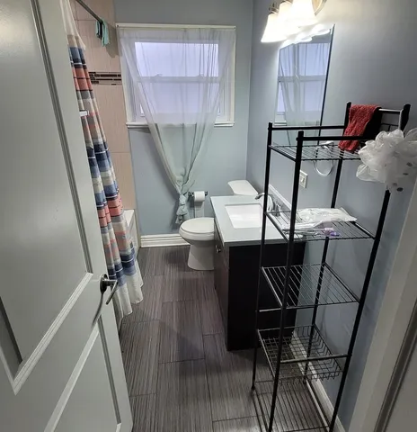 a view of a room with furniture and wooden floor