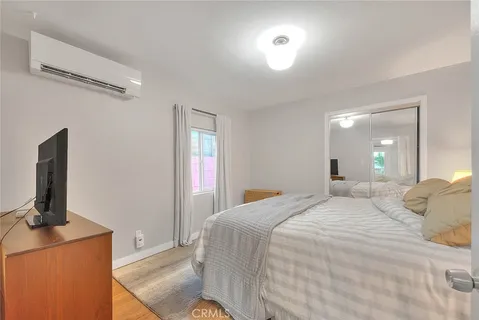 a bedroom with a bed and a flat screen tv