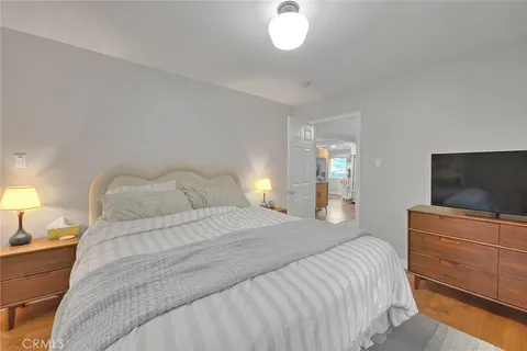 a bedroom with a bed and a flat screen tv