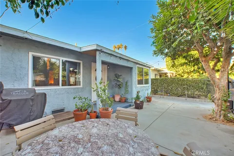 a backyard of a house with outdoor seating