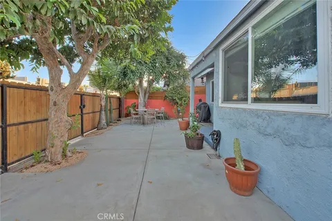 a backyard of a house with fire pit and outdoor seating
