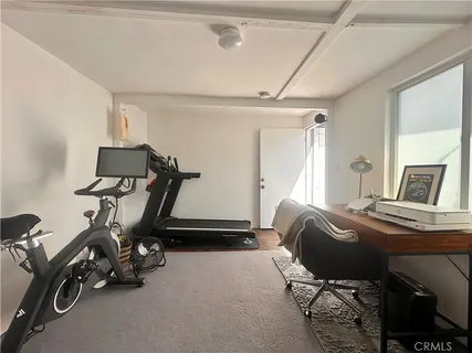 a room with gym equipment and windows