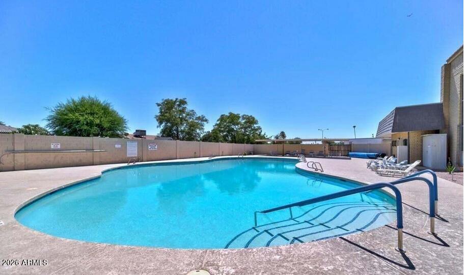 5437 East Butte Street Mesa, AZ 85205 - Photo 45 of 56 a view of a swimming pool and lounge chairs