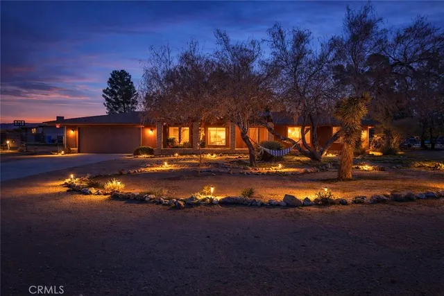 a view of a lake in front of house with green space