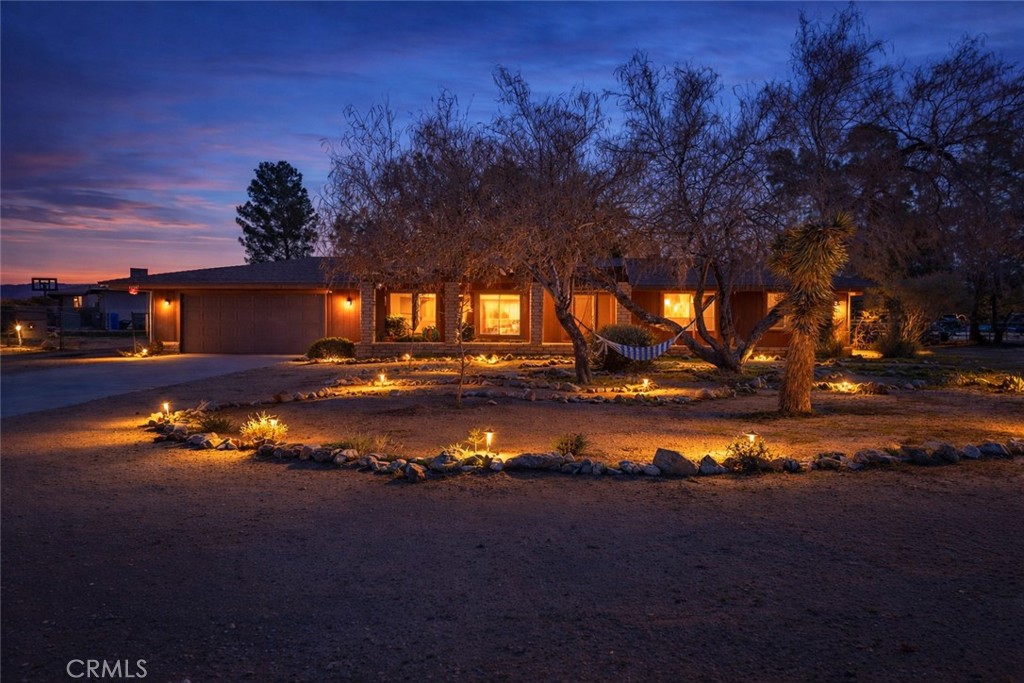 a view of a lake in front of house with green space