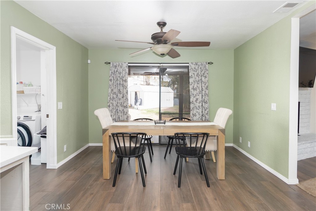 19801 Talihina Road Apple Valley, CA 92307 - Photo 11 of 32 a view of a dining room with furniture window and wooden floor