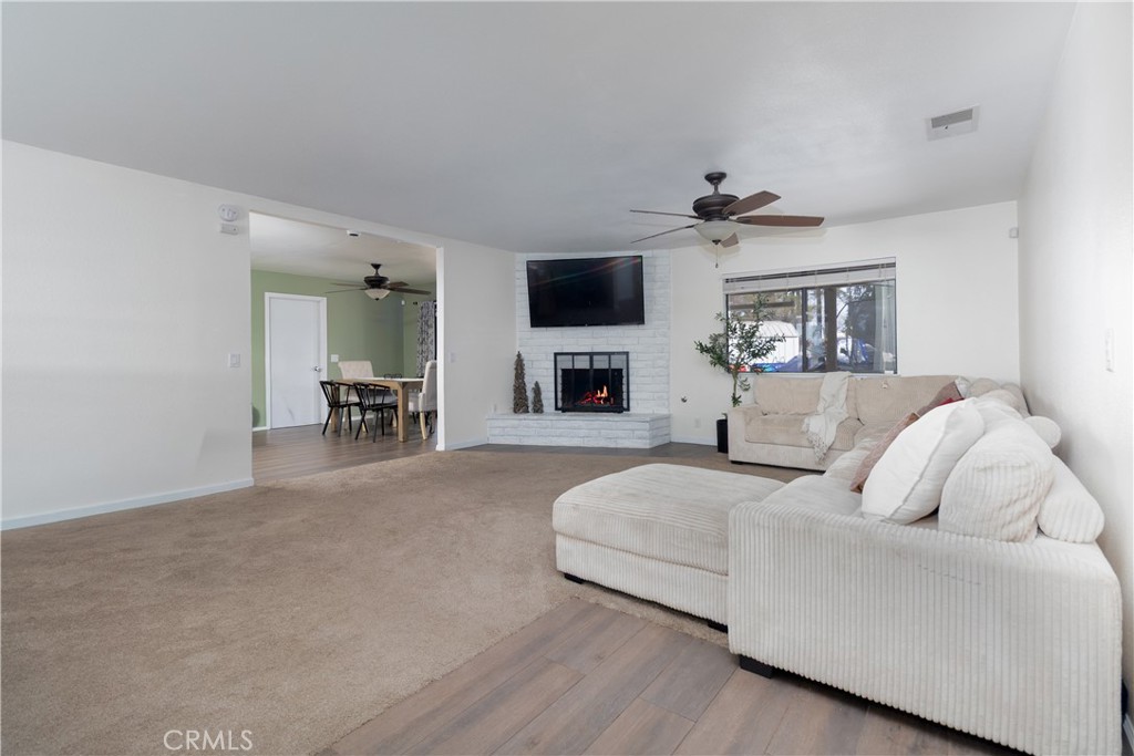 19801 Talihina Road Apple Valley, CA 92307 - Photo 13 of 32 a living room with furniture and a flat screen tv
